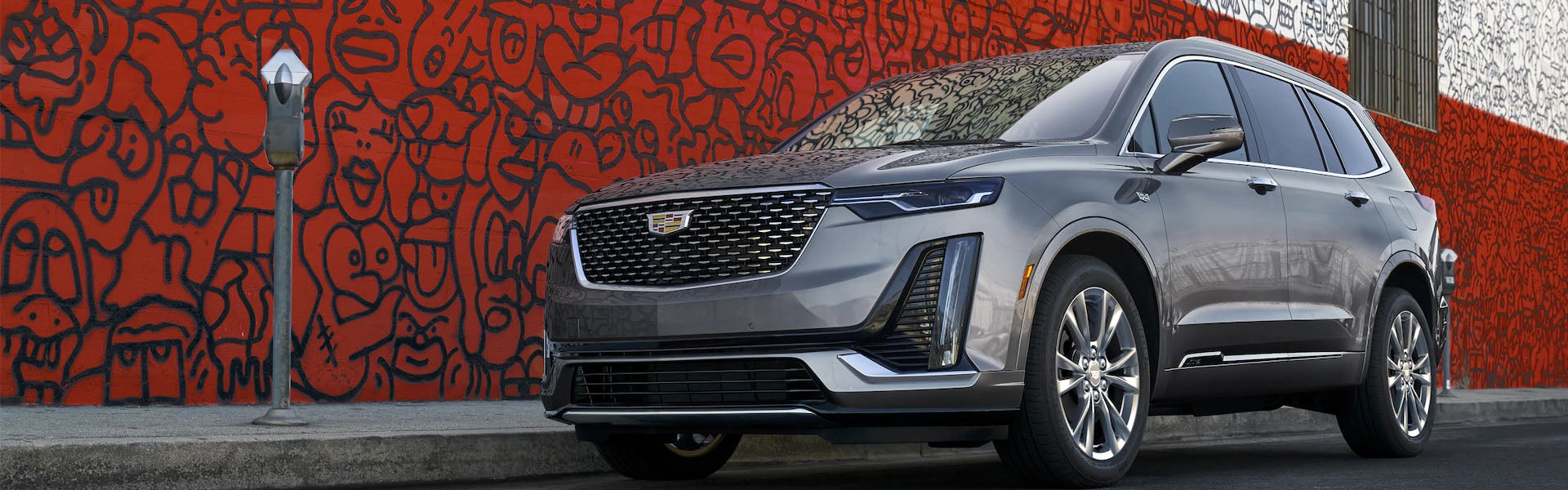 Cadillac XT6 parked on the roadside, showcasing its elegant design and spacious profile