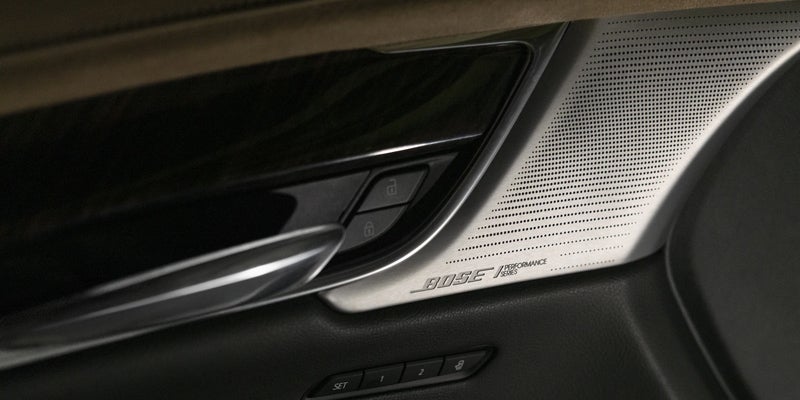 Close-up of the Cadillac XT6 interior door handle, highlighting its elegant design and premium finish